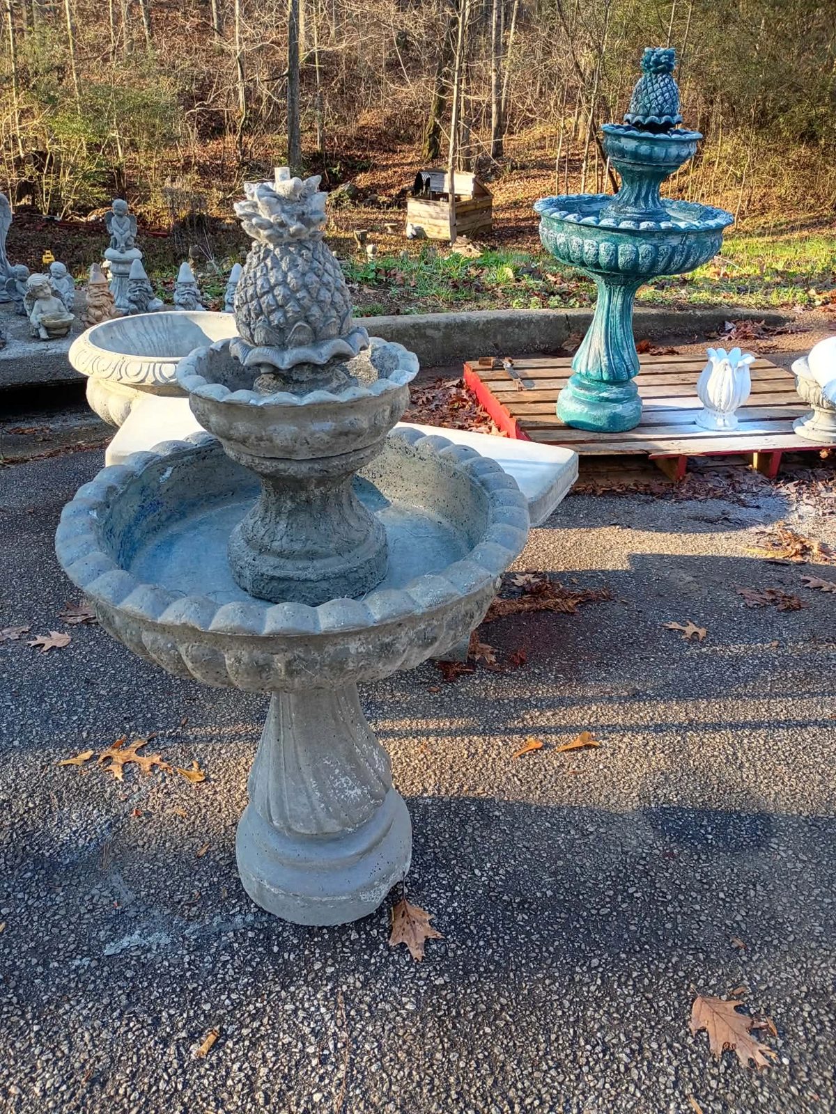 Two-tier concrete fountains in natural gray and teal with pineapple toppers, available in Villa Rica, GA — $450