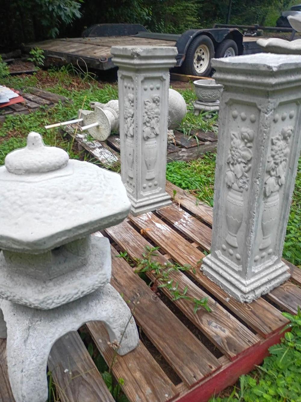 Pair of carved concrete pedestals with flower urn relief in Villa Rica, GA