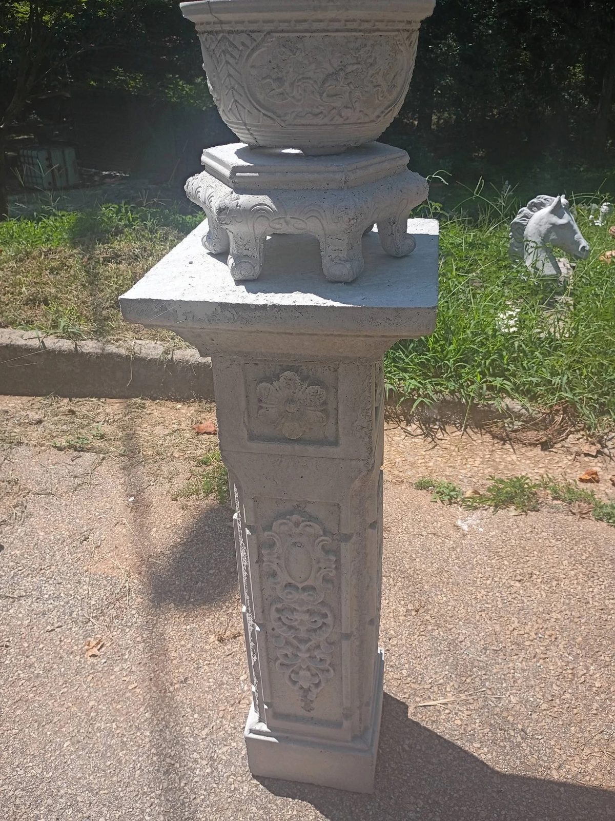 Carved concrete bowl planter on an ornate footed stand and carved pedestal in Villa Rica, GA