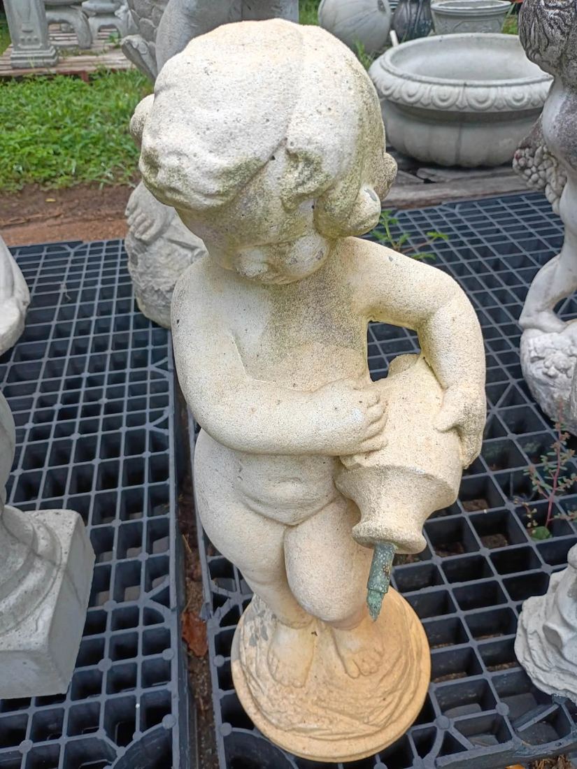 Weathered concrete cherub holding a water jug, available in Villa Rica, GA