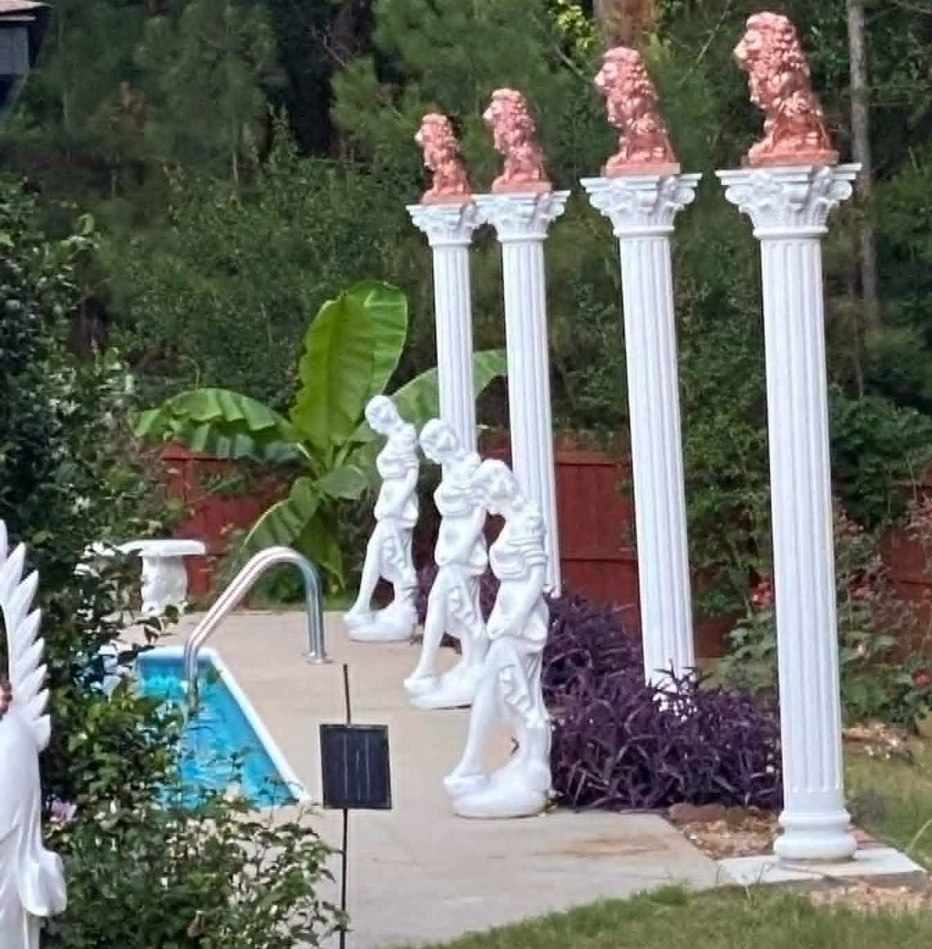 Completed backyard transformation with columns, lion statues, and poolside sculptures by Garden Fountains Yard Sculptures