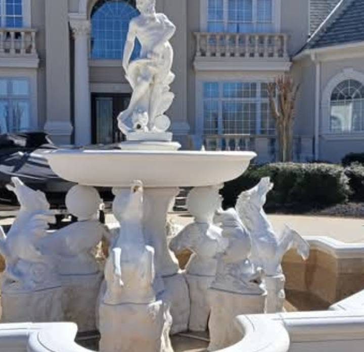 Large white marble fountain with horse and figure sculptures installed at a Georgia home