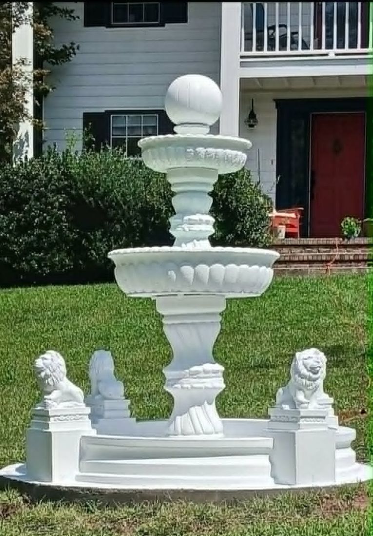 Bright white Majestic fountain with lion surround set up on a front lawn