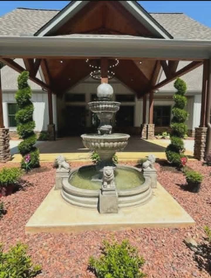 Tiered Clover fountain with lion pool surround at a covered entrance