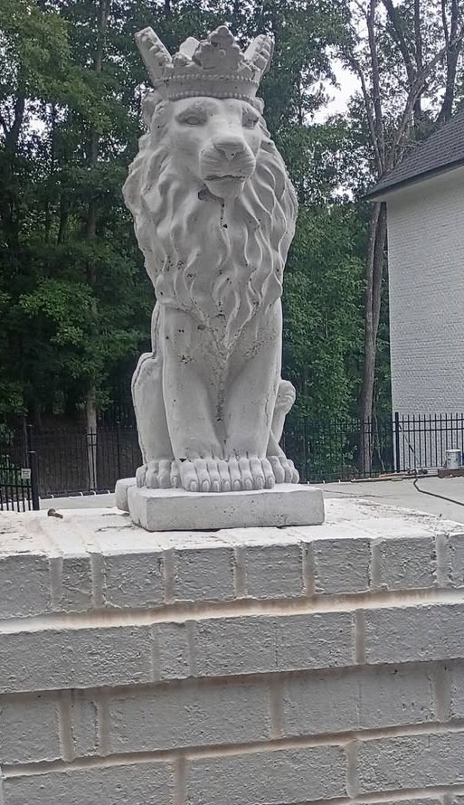 Crowned lion statue finished and set on a white brick driveway pillar in Georgia