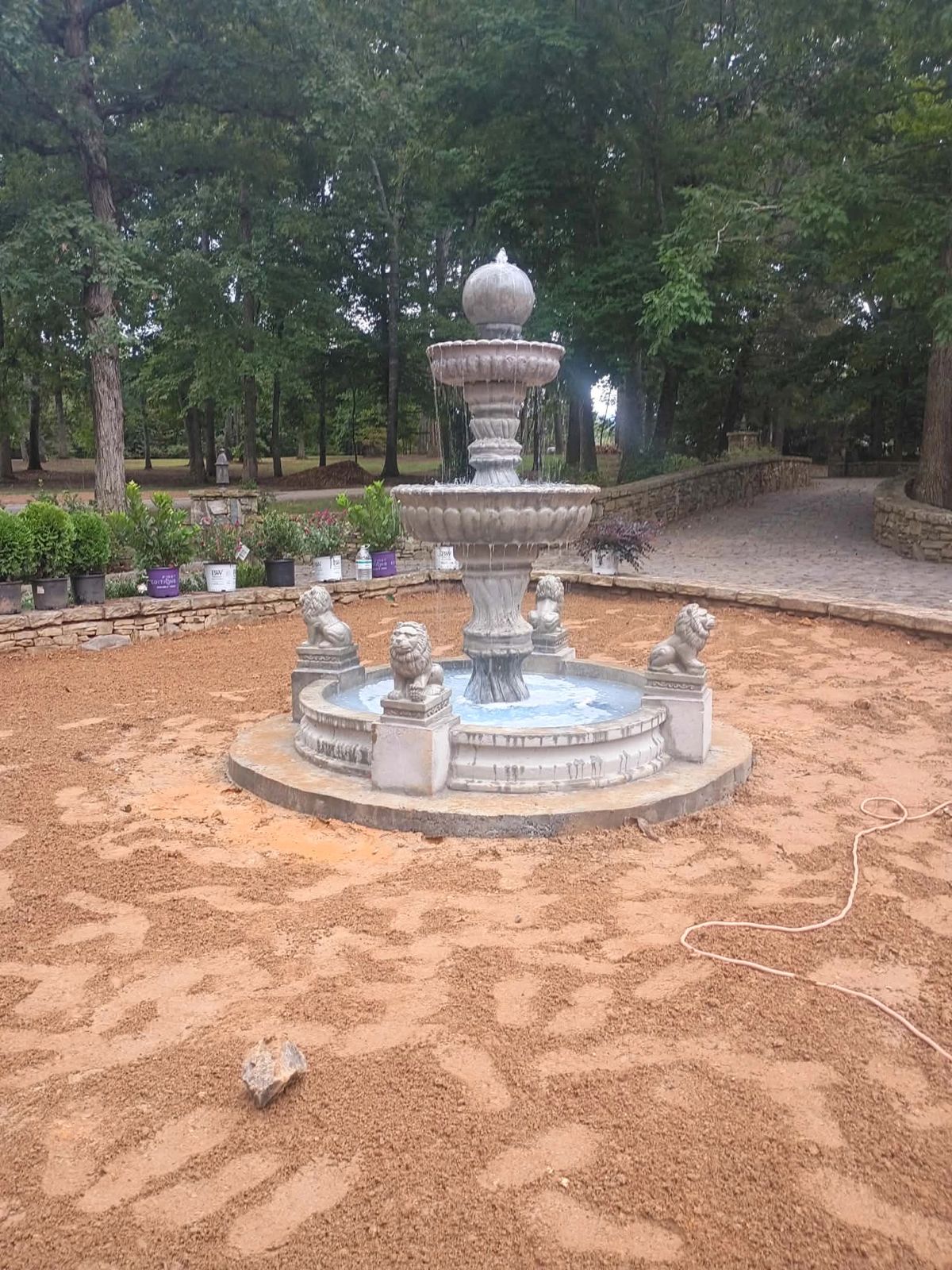 The newest Majestic fountain, a three-tier ball-top fountain with four lion statues on pedestal blocks, running in a stone-walled circle