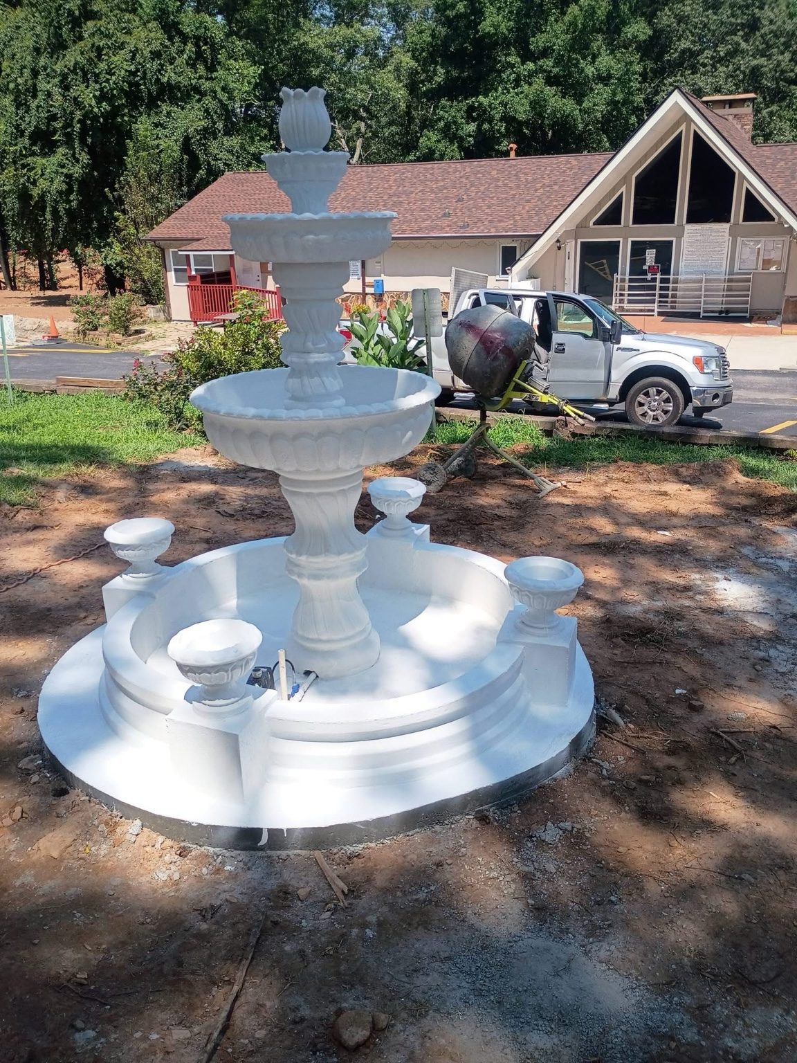 A freshly installed Majestic fountain in bright white with planter blocks and a flower topper, Villa Rica, GA