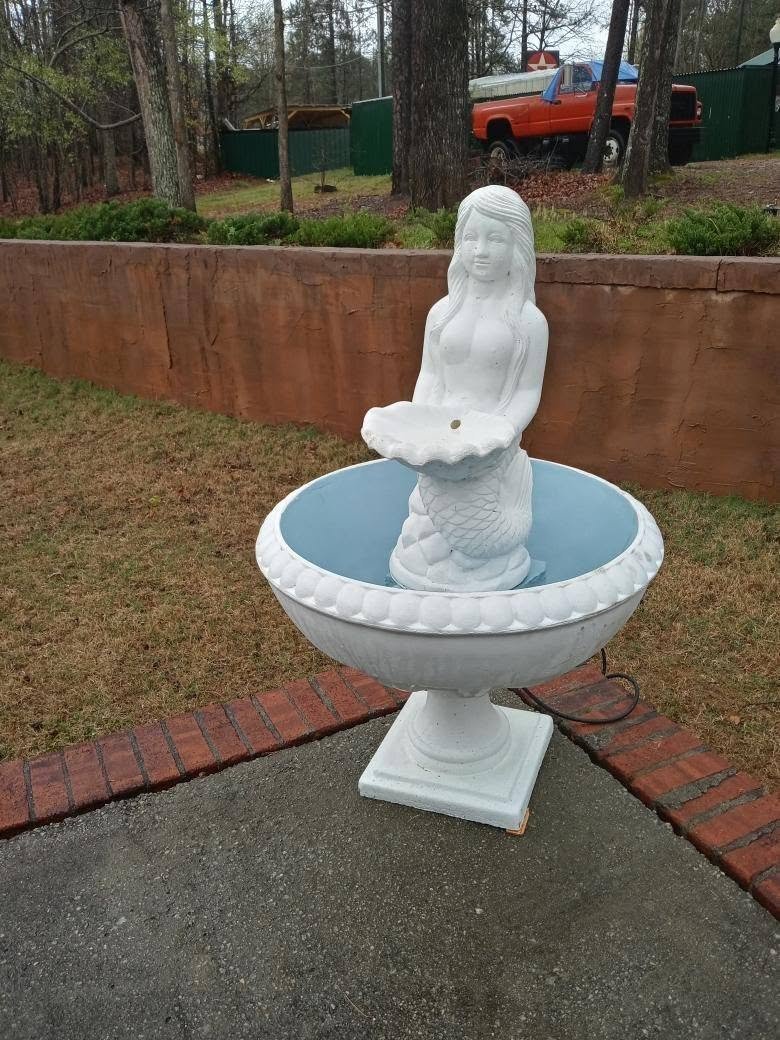 White mermaid shell fountain with a soft blue bowl, delivered and set in a Georgia yard