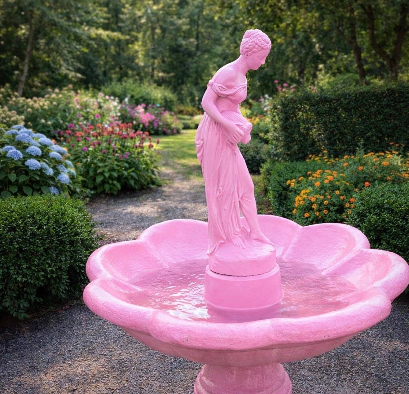 Pink lady garden fountain in a flowering garden