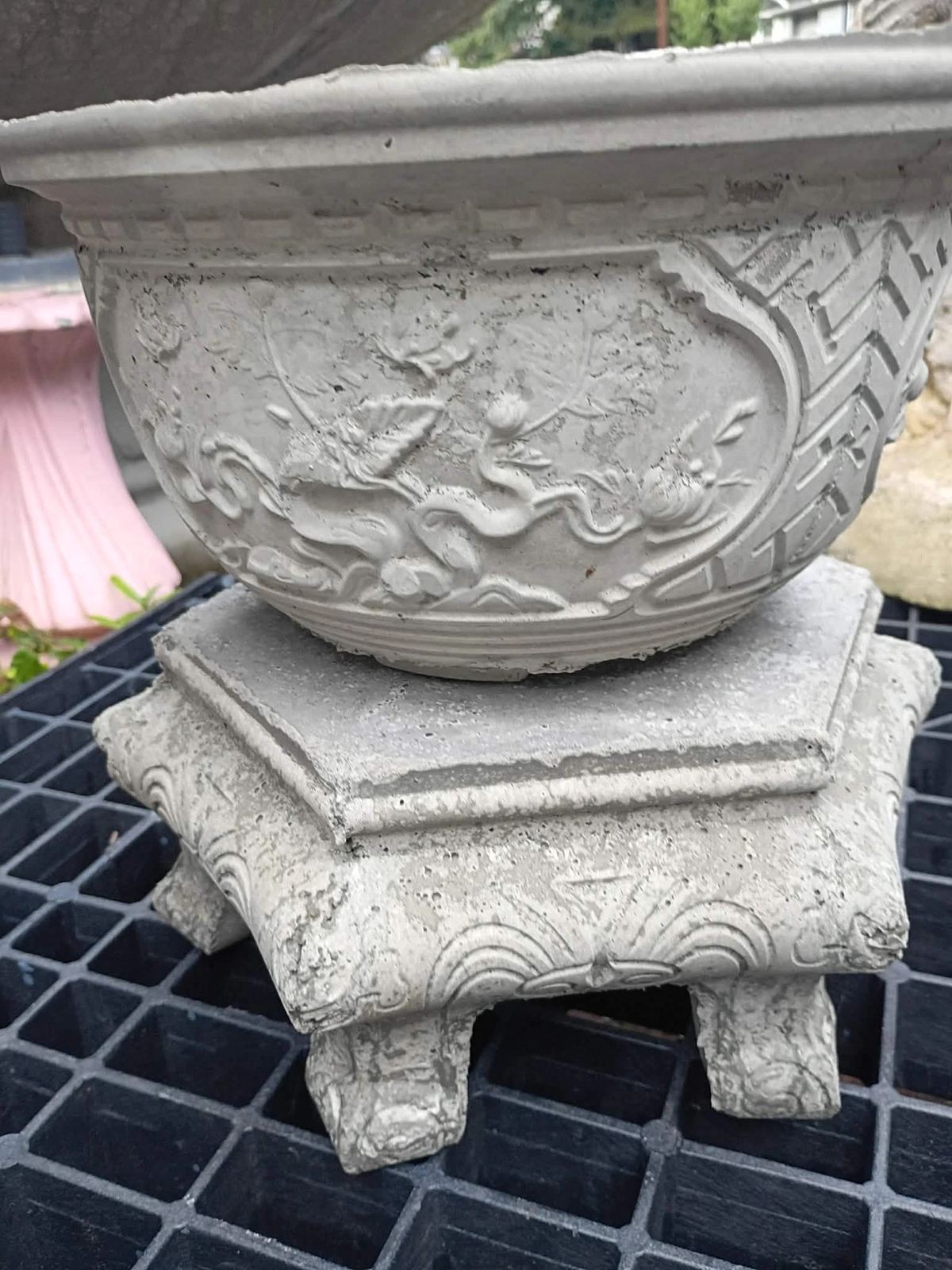 Round carved concrete bowl planter on a footed base, handcrafted in Villa Rica, GA