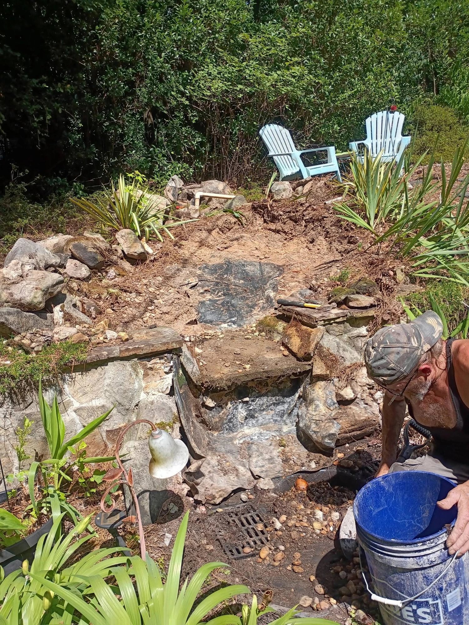 Tearing out the old pond liner and rebuilding the stone falls by hand