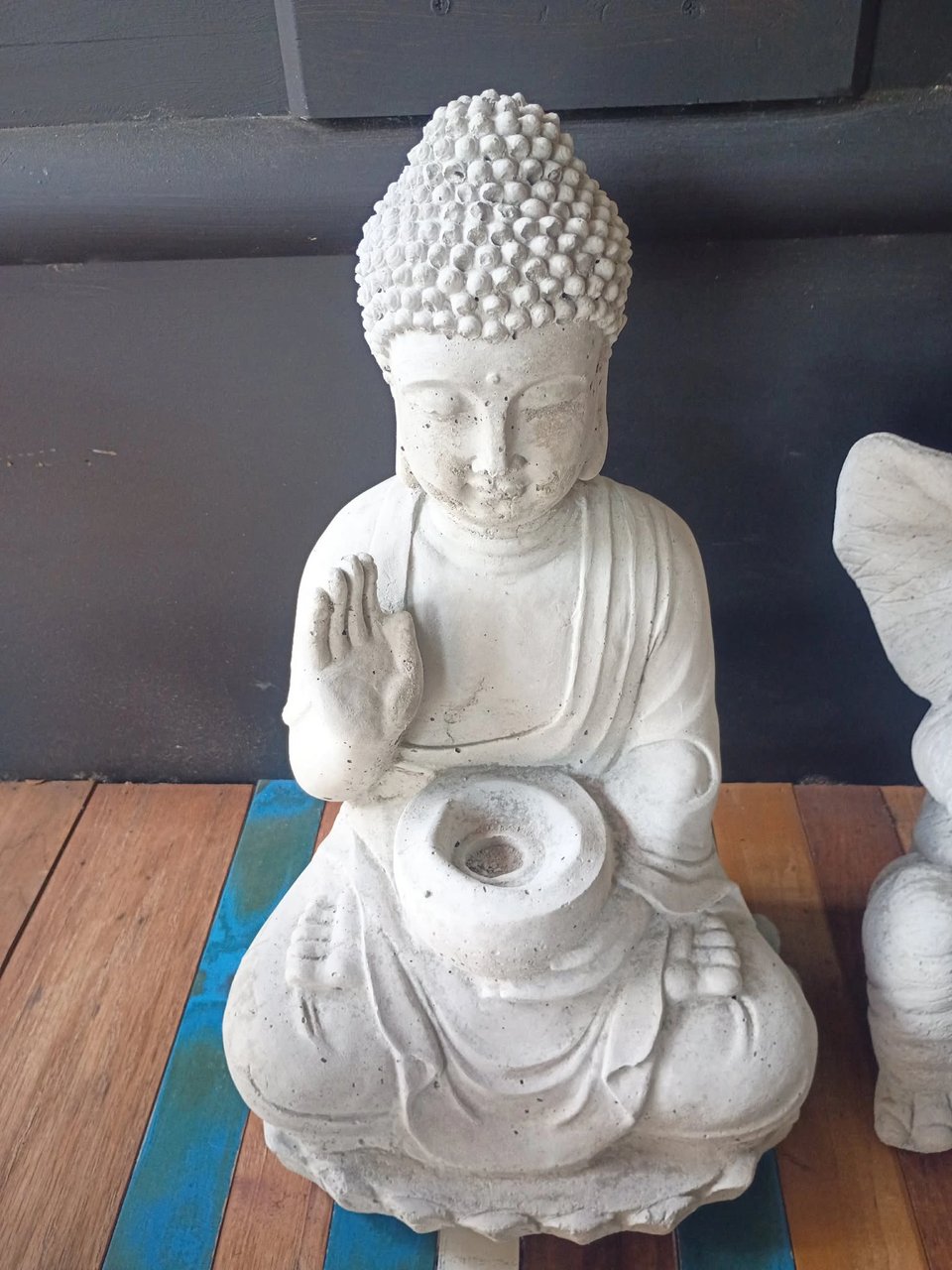 Concrete sitting Buddha with offering bowl on display at Red Door Antiques in LaGrange, GA