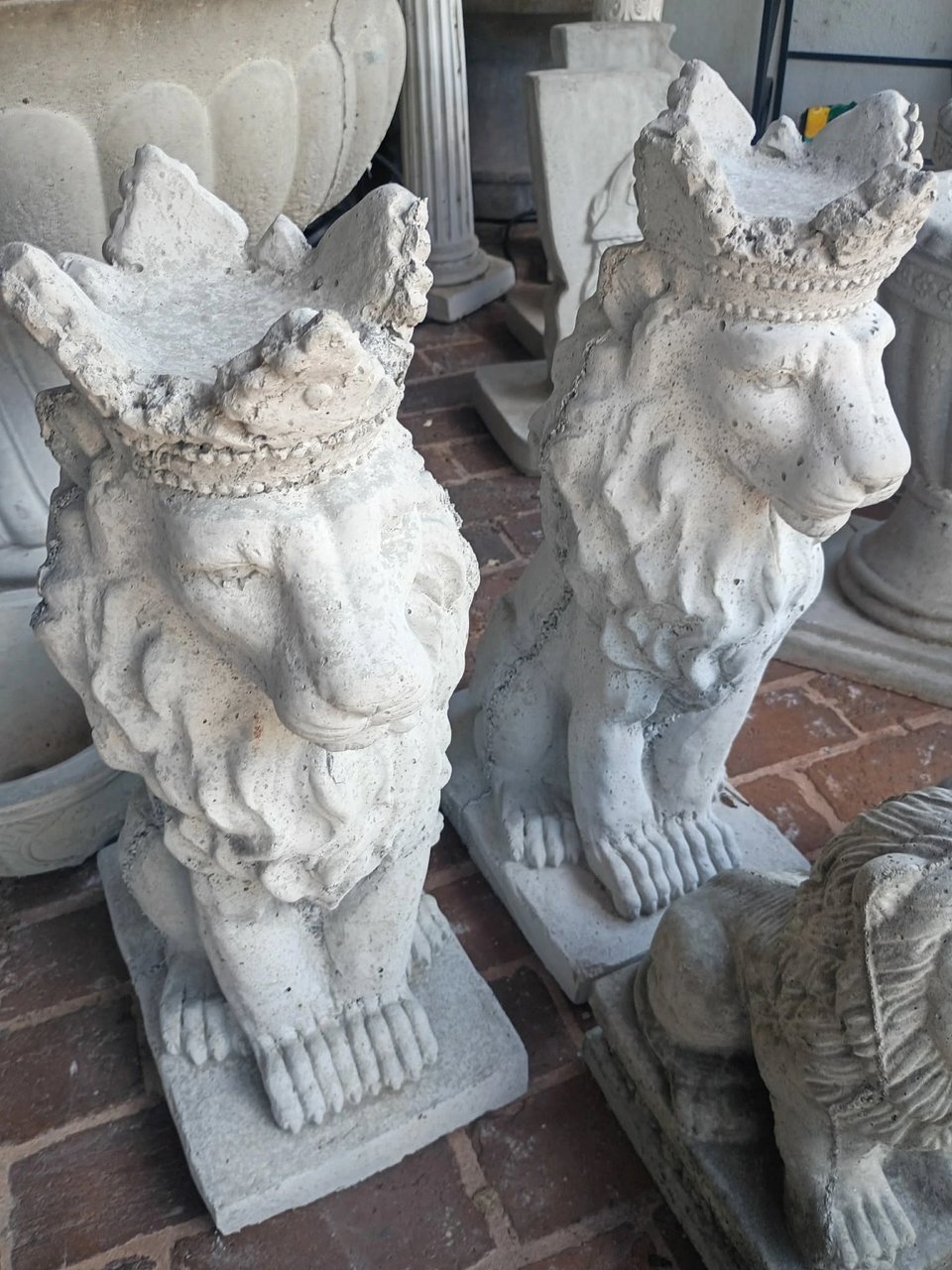 Pair of concrete crowned lion statues on display at Red Door Antiques in LaGrange, GA