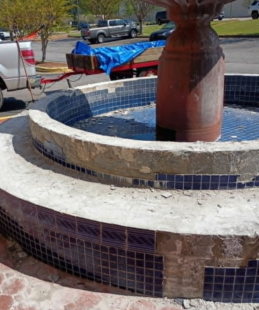 Old tile being removed from the fountain basin walls