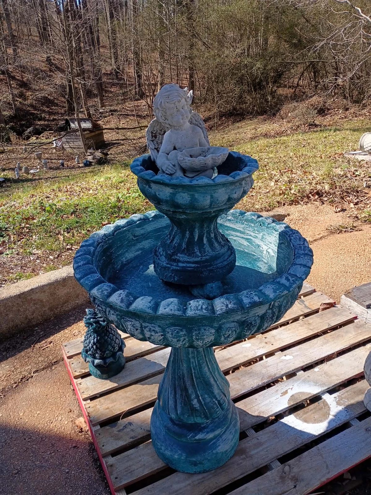 Cherub topper option on a bright teal two-tier concrete fountain — $450