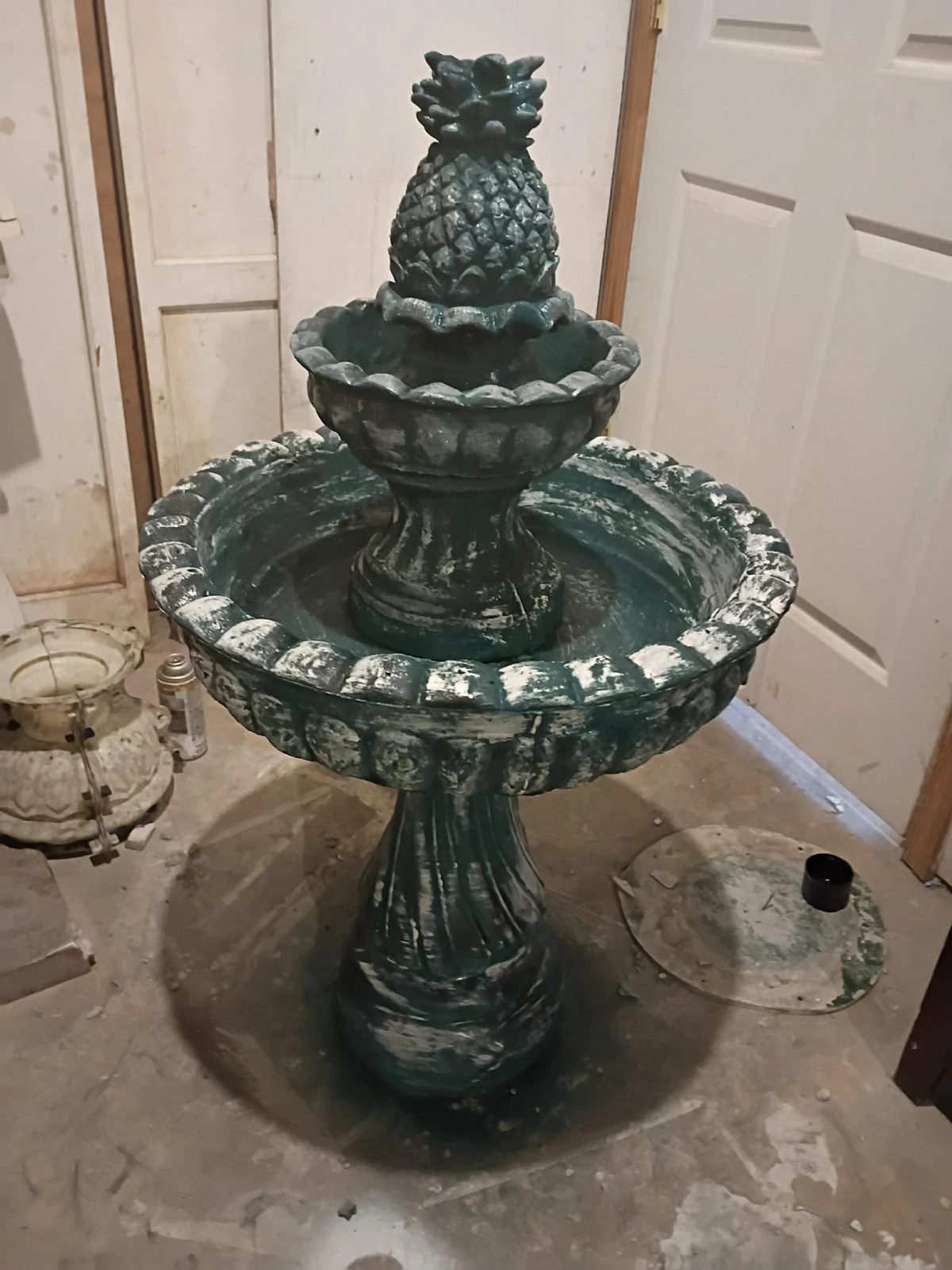 Two-tier pineapple fountain hand-finished in a deep teal patina at the shop